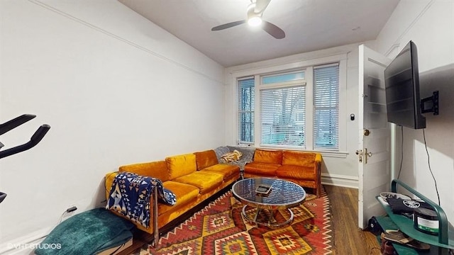 living area with wood finished floors, ceiling fan, and baseboards
