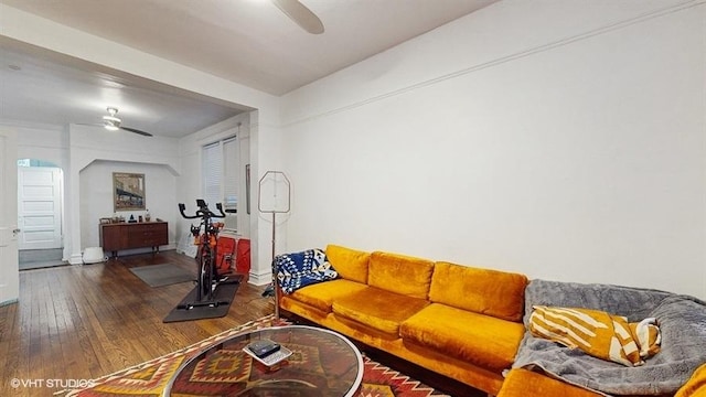 living room with hardwood / wood-style floors, baseboards, and ceiling fan