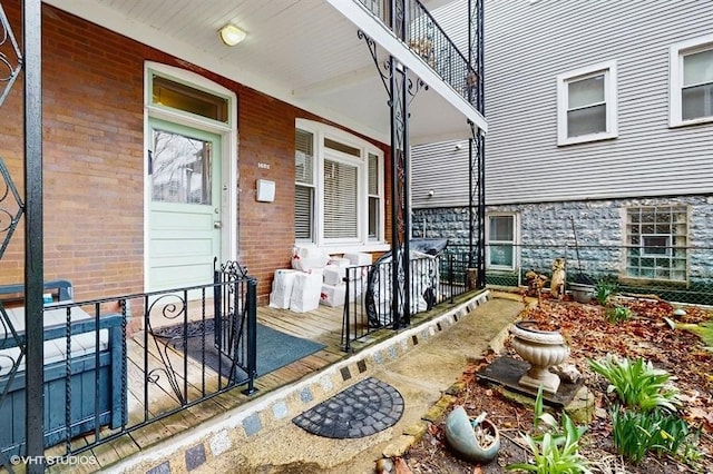 exterior space with covered porch and brick siding