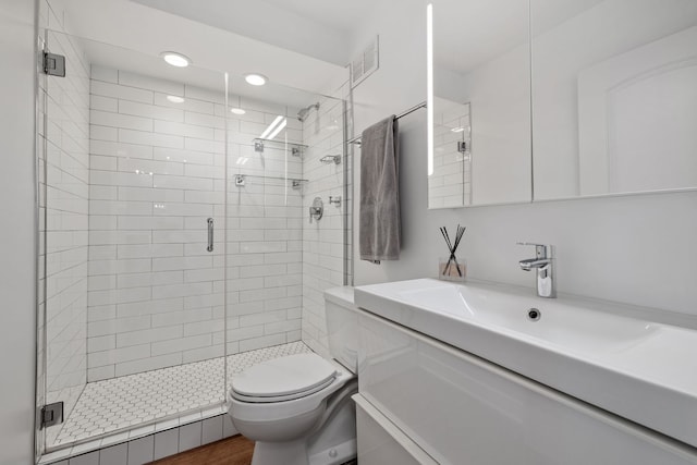 full bath with vanity, visible vents, toilet, and a shower stall