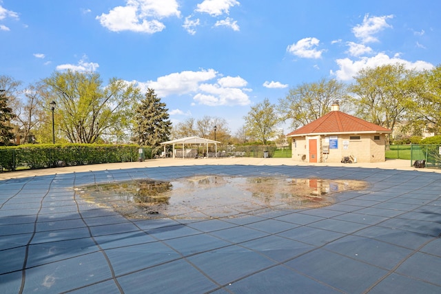 community pool featuring a patio area and fence