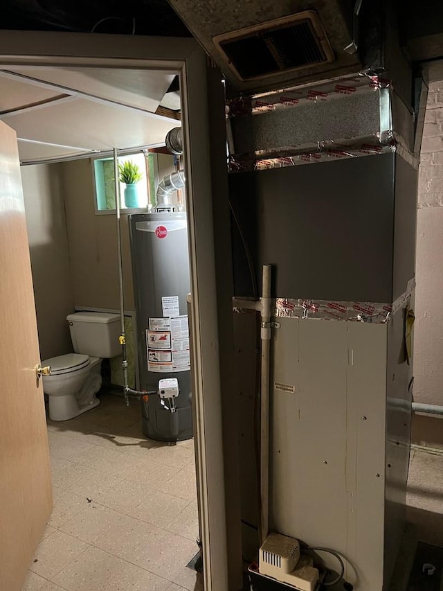 utilities featuring gas water heater and visible vents