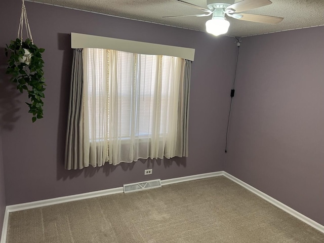 unfurnished room featuring visible vents, ceiling fan, baseboards, and carpet floors