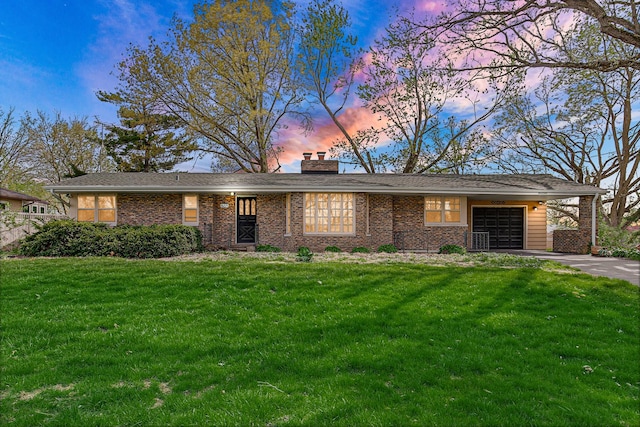 view of front of property featuring concrete driveway, a garage, a chimney, and a front lawn