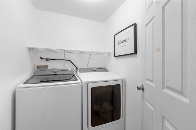 laundry area with separate washer and dryer and laundry area
