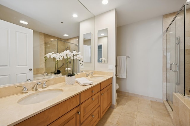 full bath featuring a sink, tile patterned floors, a shower stall, and toilet