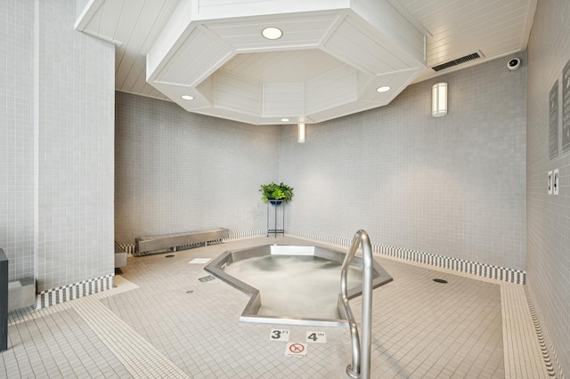 interior space with tile walls and tile patterned flooring