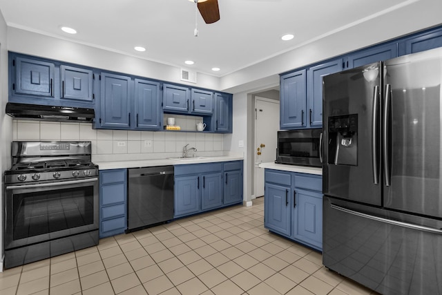 kitchen with blue cabinets, a sink, under cabinet range hood, and stainless steel appliances