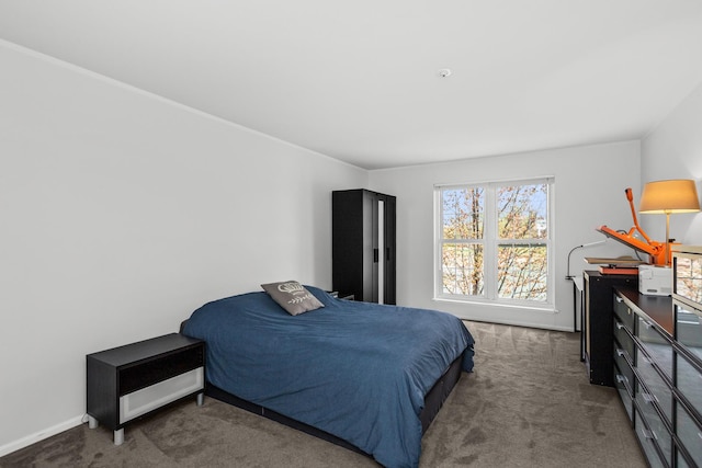 carpeted bedroom featuring baseboards