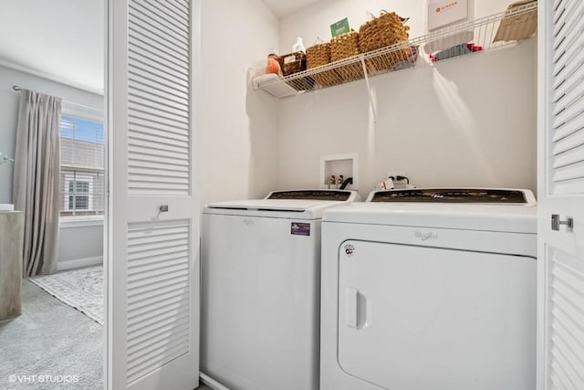 laundry area featuring washing machine and clothes dryer, laundry area, baseboards, and carpet