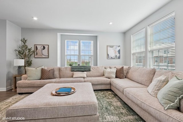 living room featuring recessed lighting, baseboards, and wood finished floors