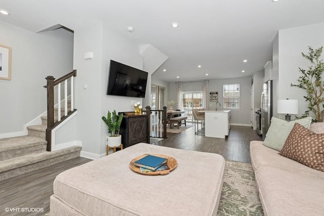 living area with stairway, baseboards, recessed lighting, and dark wood finished floors