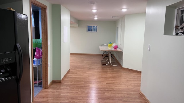 hall featuring baseboards and wood finished floors