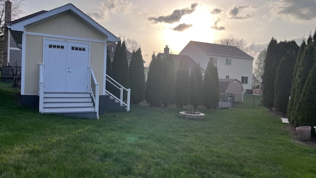 view of yard with entry steps, fence, and an outbuilding