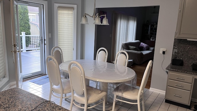 dining room featuring light tile patterned flooring and baseboards