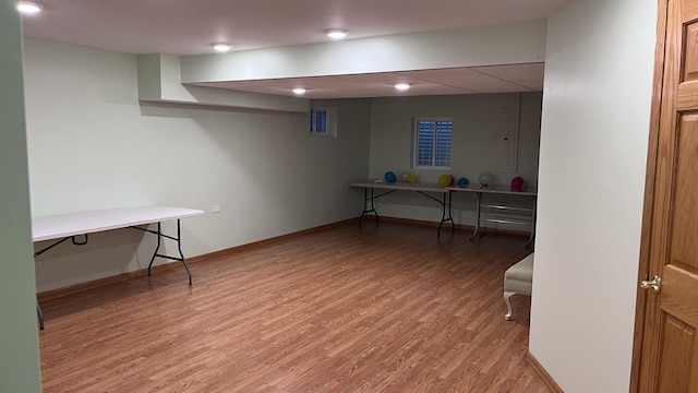 unfurnished office featuring baseboards and light wood-style flooring