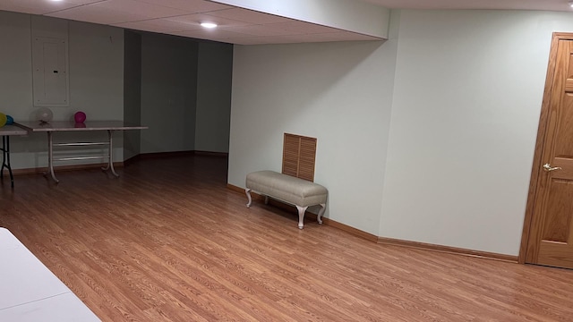 interior space featuring visible vents, light wood-style flooring, baseboards, and electric panel