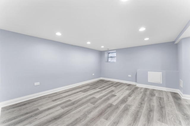 basement with baseboards, recessed lighting, and wood finished floors