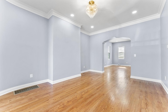 unfurnished room featuring recessed lighting, arched walkways, an inviting chandelier, baseboards, and visible vents