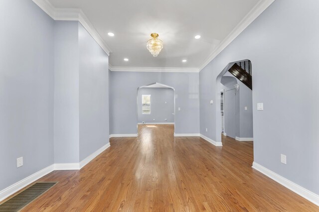 interior space with recessed lighting, visible vents, light wood-style flooring, baseboards, and arched walkways