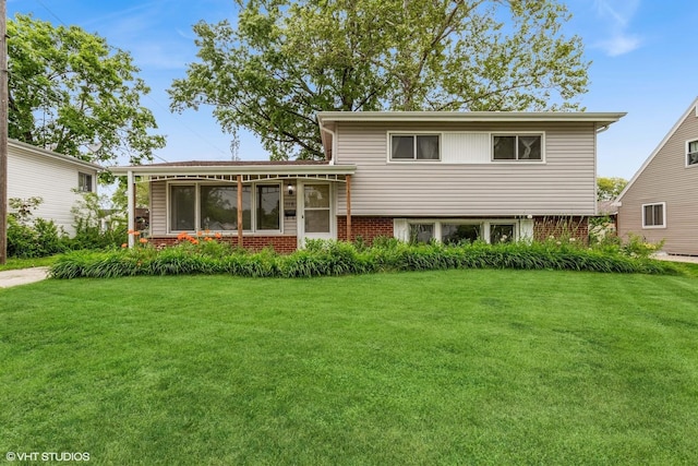 116 E Armitage Ave, Addison, IL 60101 - view of front of home with brick siding, a front yard, and a sunroom