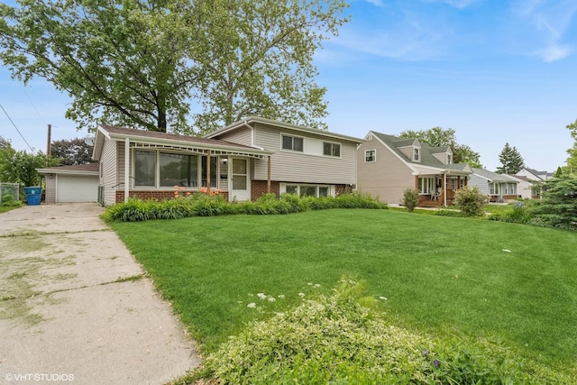 116 E Armitage Ave, Addison, IL 60101 - tri-level home featuring brick siding, a front lawn, a sunroom, and a detached garage