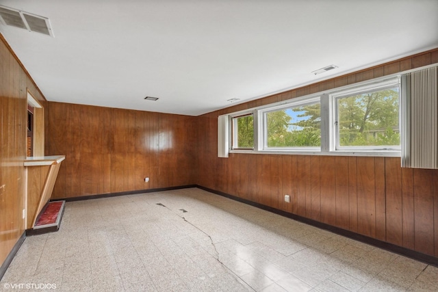 116 E Armitage Ave, Addison, IL 60101 - spare room with light floors, wooden walls, and baseboards