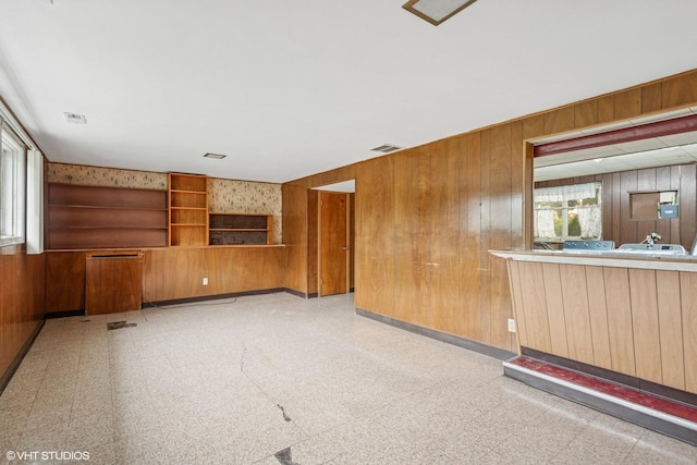 116 E Armitage Ave, Addison, IL 60101 - unfurnished living room with light flooring and wood walls