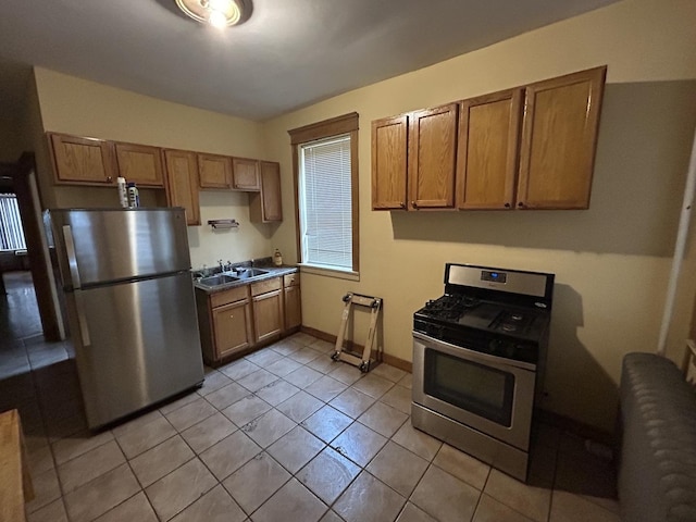 kitchen featuring a sink, appliances with stainless steel finishes, and brown cabinetry