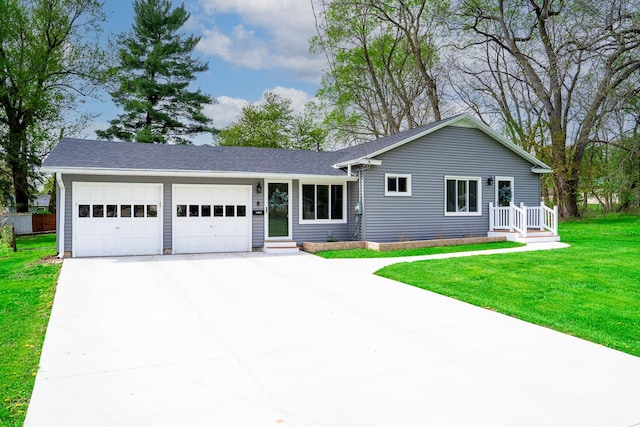 ranch-style home featuring concrete driveway, roof with shingles, a front yard, and a garage