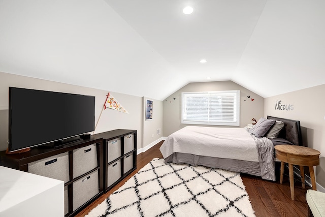 bedroom featuring baseboards, dark wood-style floors, and vaulted ceiling