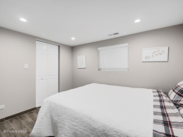 bedroom with recessed lighting, visible vents, and dark wood finished floors