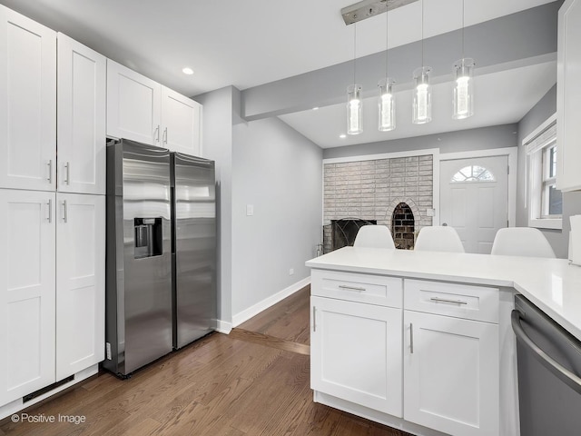 kitchen featuring appliances with stainless steel finishes, baseboards, dark wood-style floors, and white cabinetry