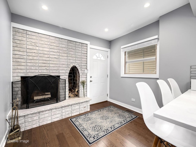interior space with baseboards, a fireplace, recessed lighting, and wood finished floors