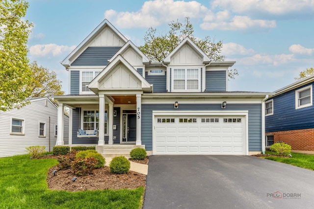 craftsman inspired home featuring board and batten siding, driveway, and a porch