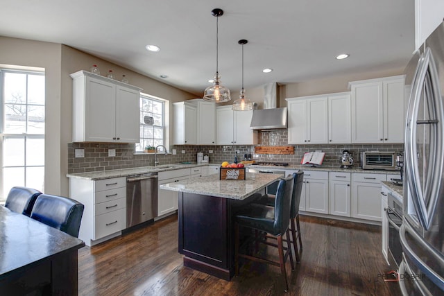 kitchen featuring appliances with stainless steel finishes, dark wood-style floors, open floor plan, recessed lighting, and white cabinetry