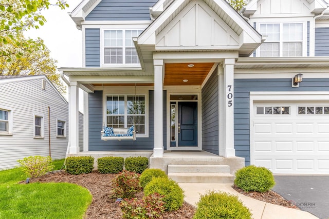 traditional-style house featuring a garage, board and batten siding, a porch, and aphalt driveway