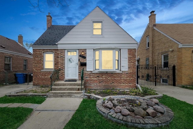 view of front of house with brick siding, fence, and a fire pit