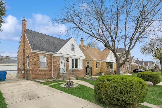 view of front of property with brick siding, roof with shingles, fence, and a chimney