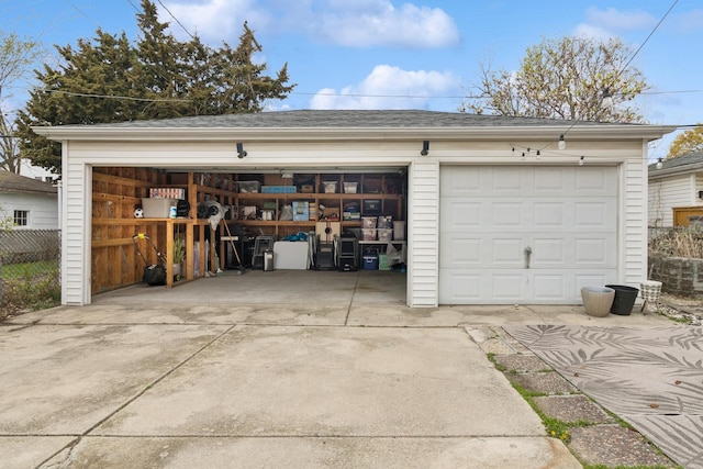 detached garage featuring fence