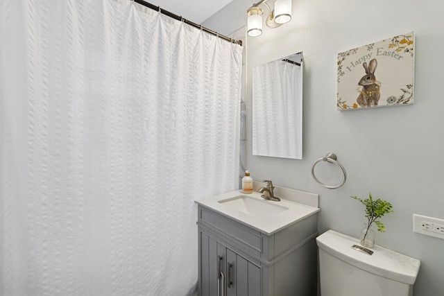 full bath featuring vanity and toilet