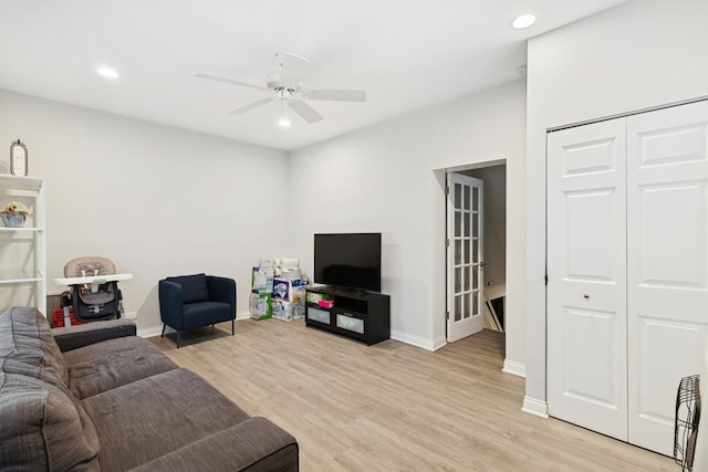 living room with a ceiling fan, baseboards, recessed lighting, and light wood-style floors
