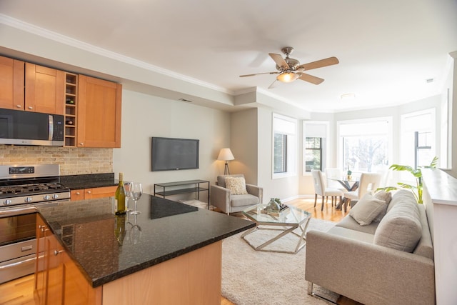 4830 N Albany Ave Unit 1N, Chicago, IL 60625 - living room with crown molding, visible vents, baseboards, light wood-type flooring, and a ceiling fan