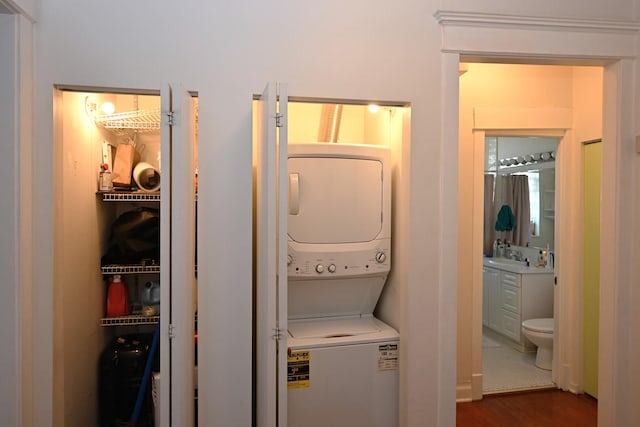 925 E 61st St Unit 3, Chicago, IL 60637 - washroom with estacked washer and dryer and dark wood finished floors