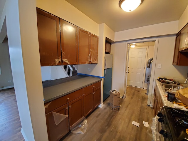 19135 Pine Dr Unit 2, Country Club Hills, IL 60478 - kitchen featuring range with gas cooktop, brown cabinets, dark wood finished floors, a sink, and freestanding refrigerator