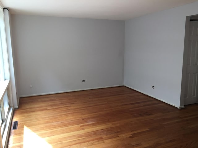 1428 E 55th St, Chicago, IL 60615 - spare room with visible vents, baseboards, and wood finished floors