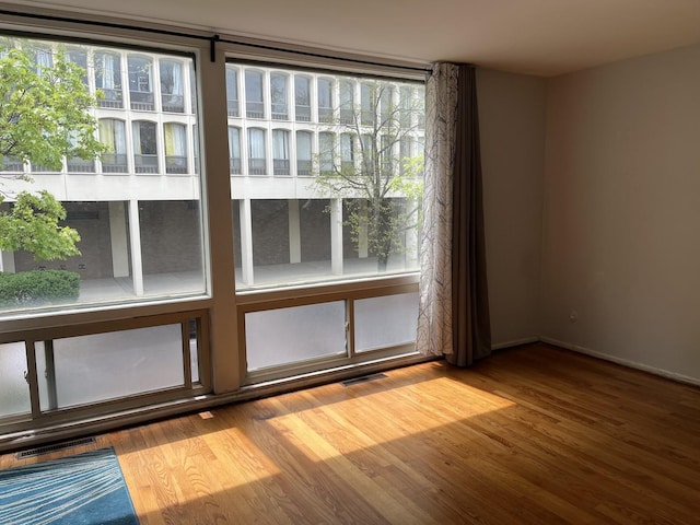 1428 E 55th St, Chicago, IL 60615 - interior space with baseboards, wood finished floors, and visible vents