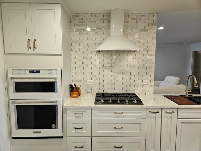 4150 W Church Rd, Beecher, IL 60401 - kitchen featuring double oven, wall chimney range hood, white cabinets, a sink, and black gas stovetop