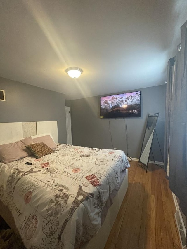 bedroom with wood-type flooring and visible vents