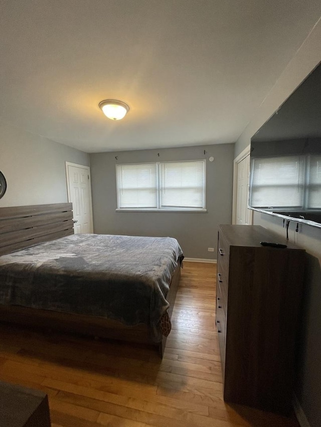 bedroom with baseboards and wood finished floors